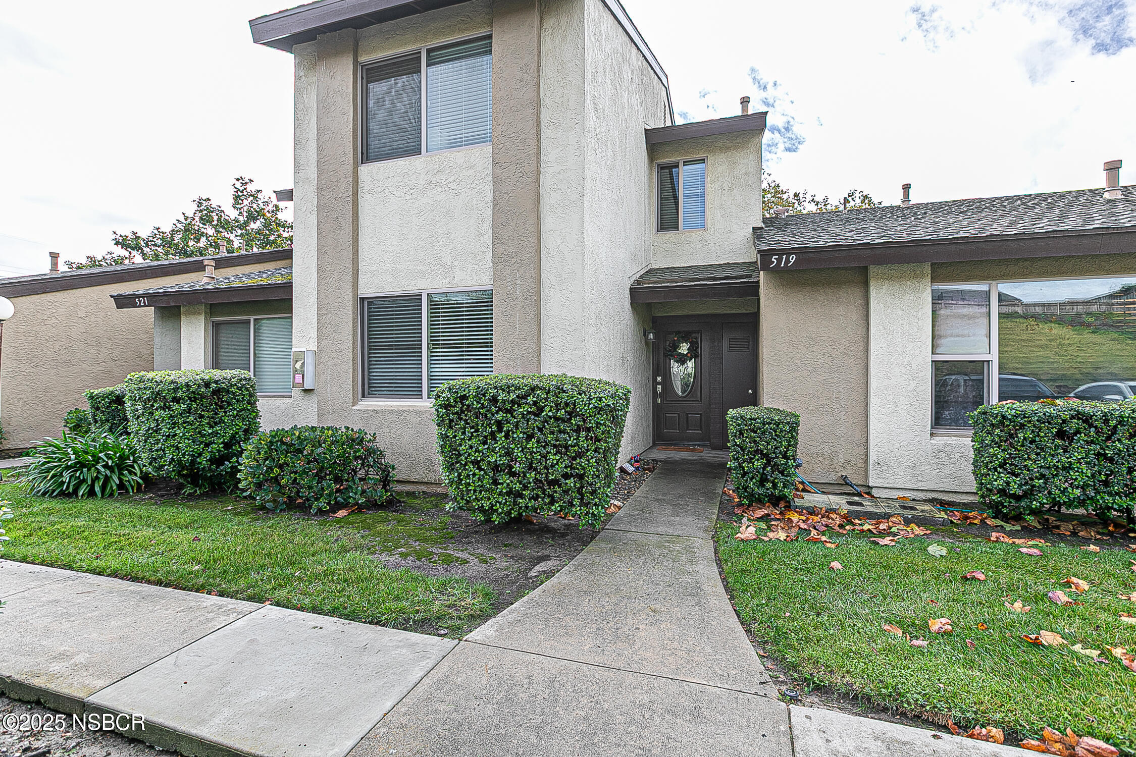 a front view of a house with garden