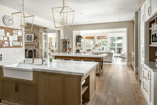 a dining room with furniture a chandelier and fireplace