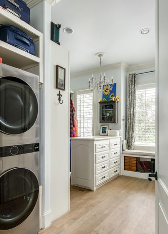 a bedroom with a bed a table and a chandelier