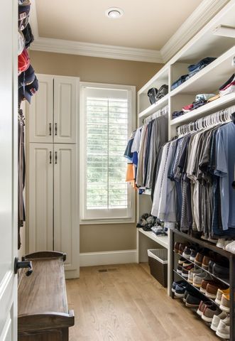 a spacious bathroom with double vanity sink a mirror a toilet and a glass door shower