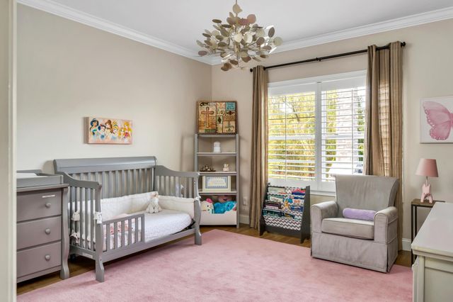 a kitchen with stainless steel appliances a refrigerator and a bookshelf
