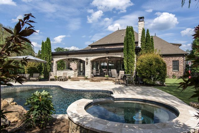 an aerial view of a house with yard swimming pool and outdoor seating