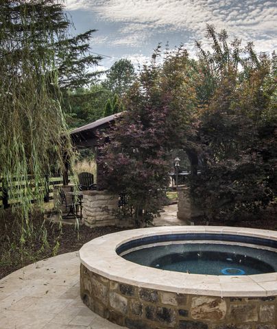 a view of patio with couches and a fire pit
