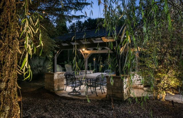 a front view of a house with a garden