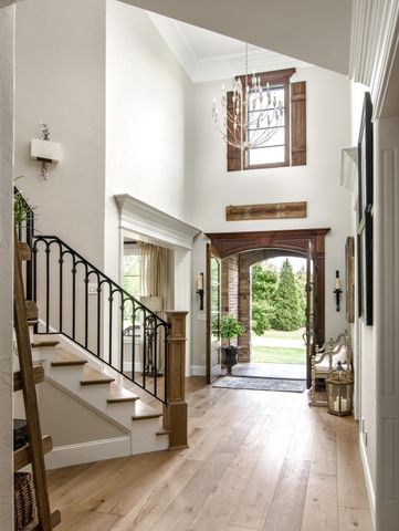 a kitchen with stainless steel appliances kitchen island granite countertop a table chairs sink and cabinets