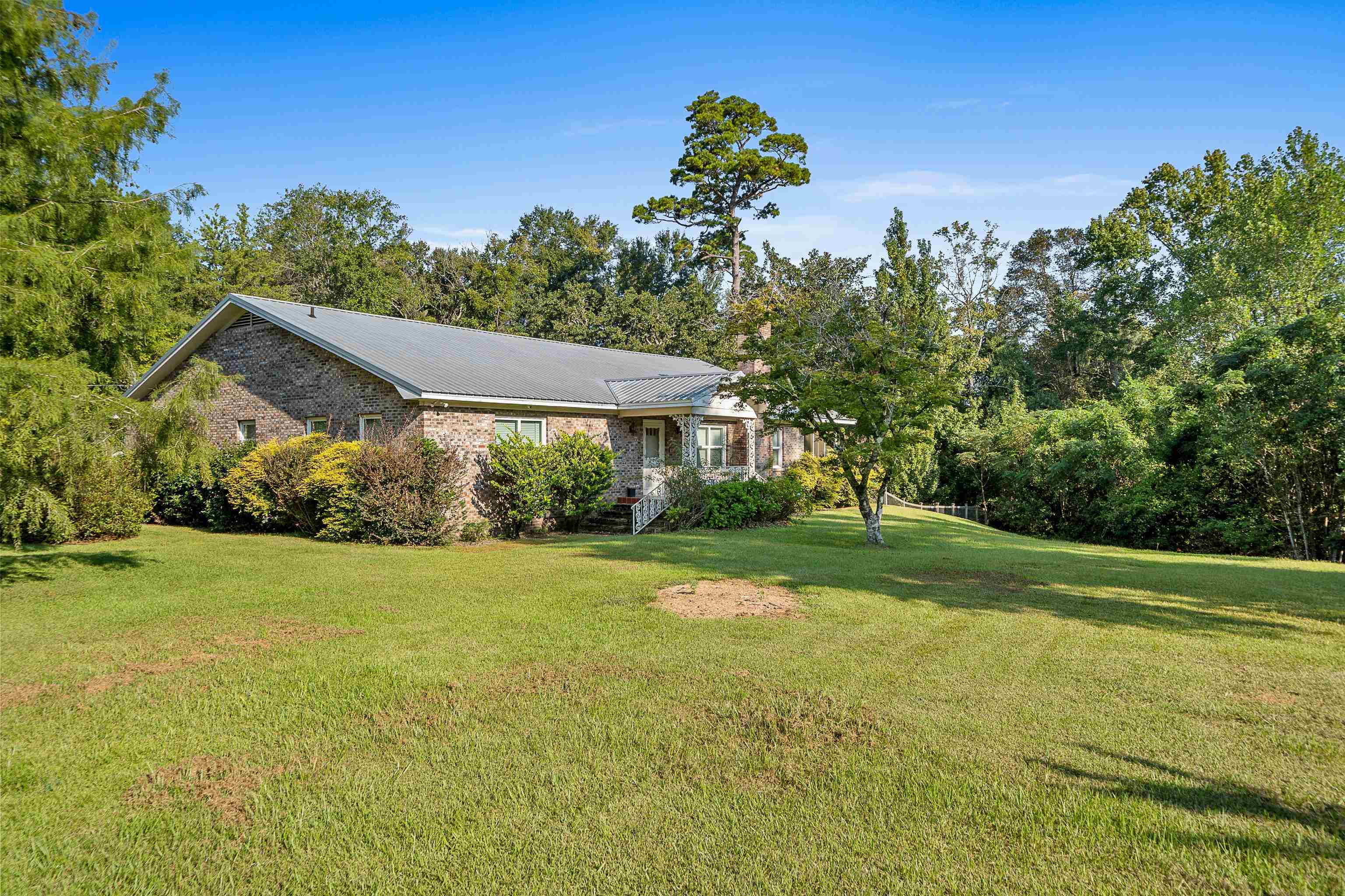 9350 Tompkins Road Stockton, AL 36579 - Photo 11 of 36 View of front facade with a front yard and view of scattered trees