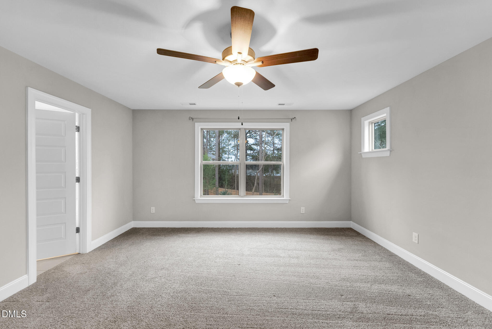 928 Barringer Drive Raleigh, NC 27606 - Photo 25 of 40 an empty room with chandelier fan and windows