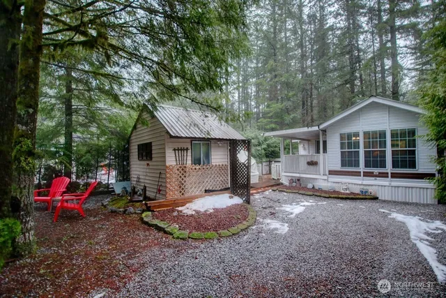 a view of a house with a yard and sitting area