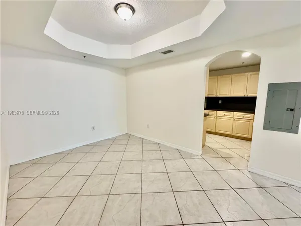 a kitchen with a sink a refrigerator and cabinets