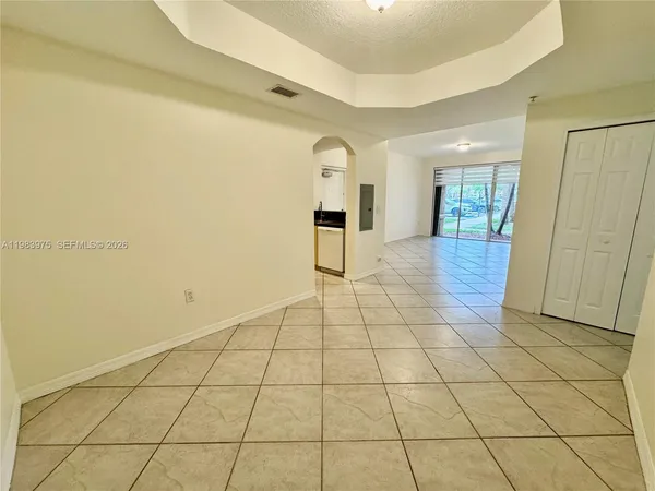 a kitchen with granite countertop a refrigerator and a stove top oven