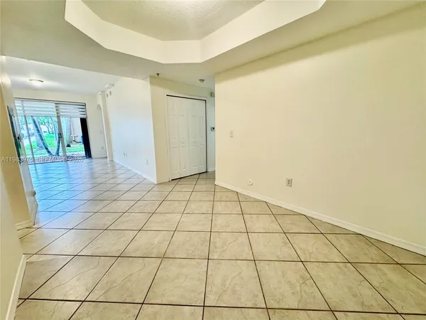 a kitchen with a refrigerator and cabinets