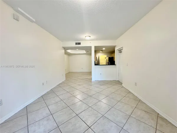 a kitchen view with a table and sofas