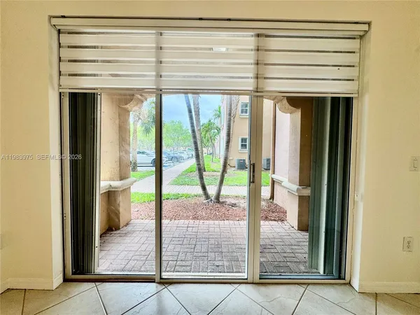 a view of a livingroom with wooden floor and natural light