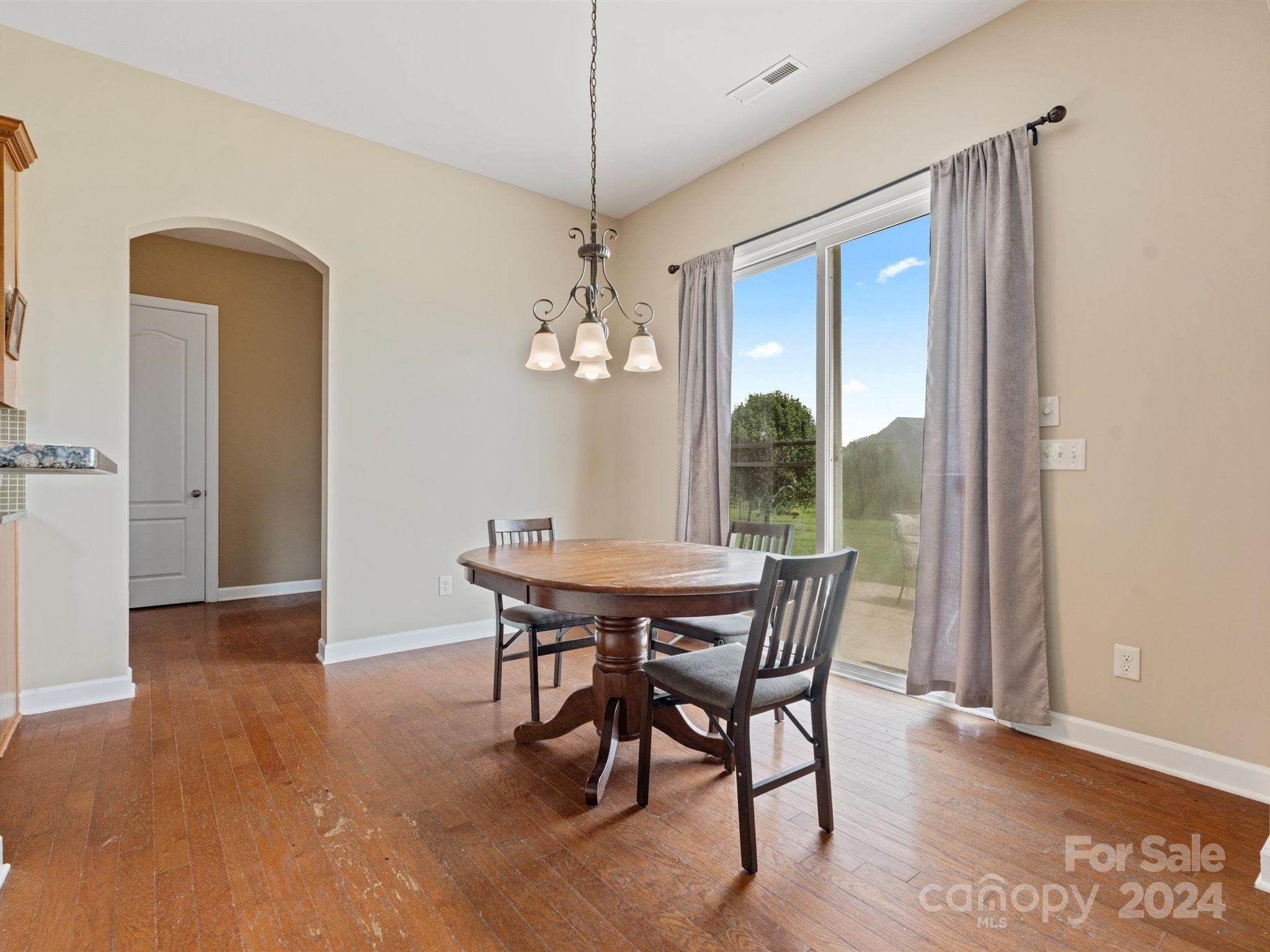 1010 Wellscroft Road Indian Trail, NC 28079 - Photo 11 of 19 a view of a dining room with furniture window and wooden floor