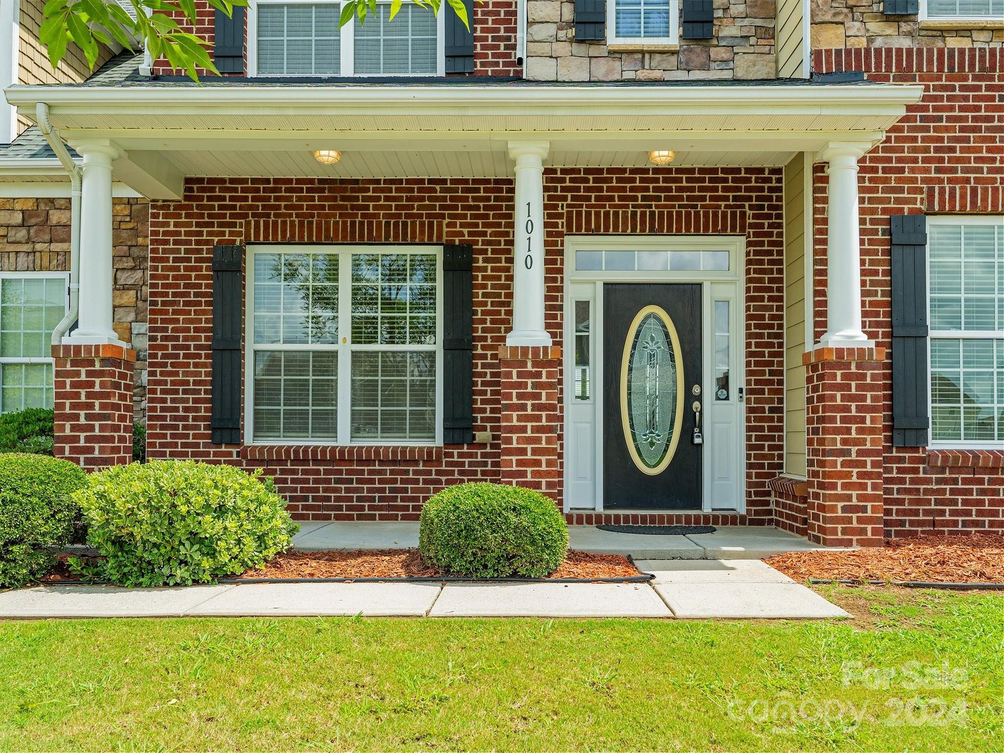 1010 Wellscroft Road Indian Trail, NC 28079 - Photo 2 of 19 a front view of a house with a garden