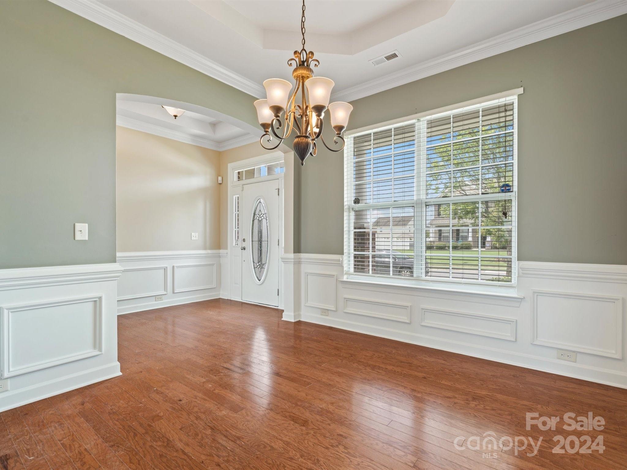 1010 Wellscroft Road Indian Trail, NC 28079 - Photo 4 of 19 a view of an empty room with a window and wooden floor