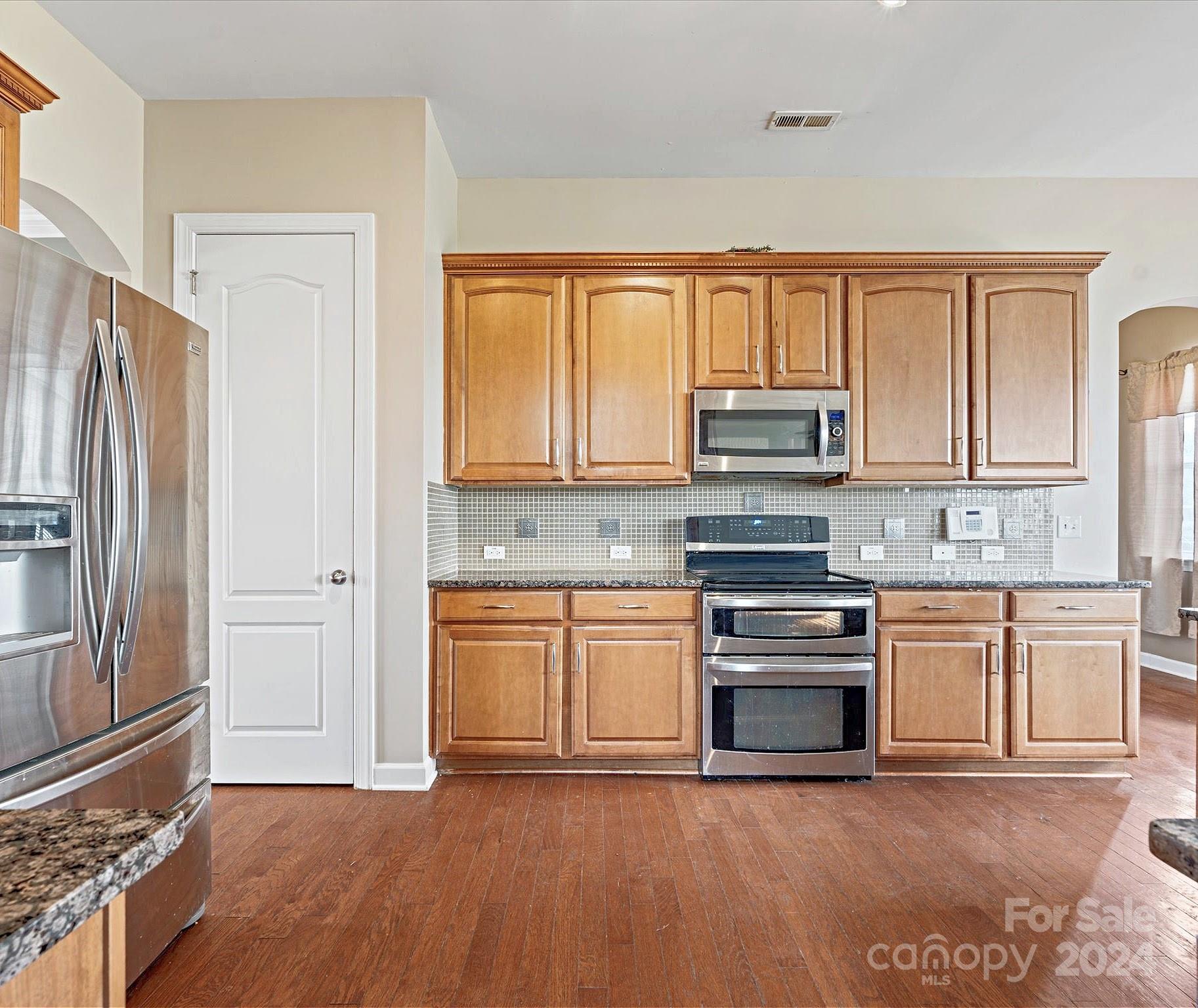1010 Wellscroft Road Indian Trail, NC 28079 - Photo 7 of 19 a kitchen with granite countertop a refrigerator stove top oven and sink