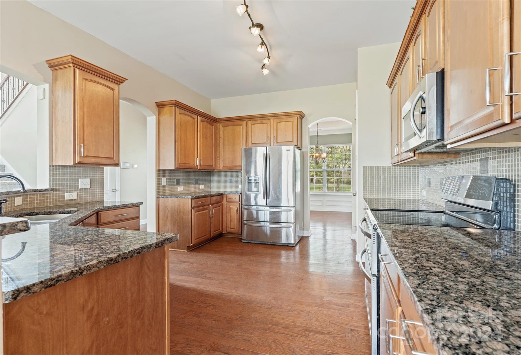 1010 Wellscroft Road Indian Trail, NC 28079 - Photo 9 of 19 a kitchen with stainless steel appliances granite countertop a stove a sink and a refrigerator