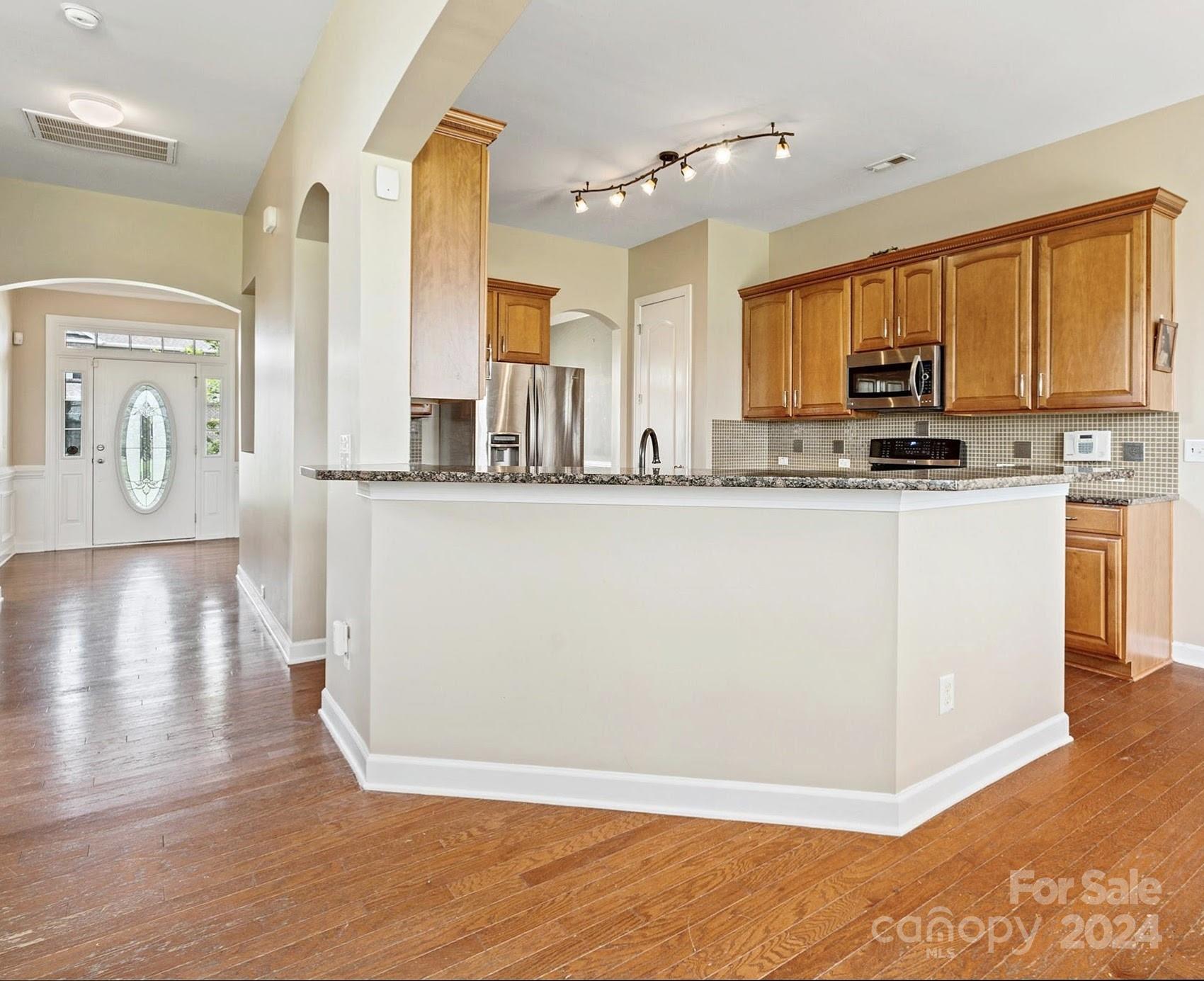 1010 Wellscroft Road Indian Trail, NC 28079 - Photo 10 of 19 a kitchen with stainless steel appliances granite countertop a sink a stove top oven a counter space and cabinets