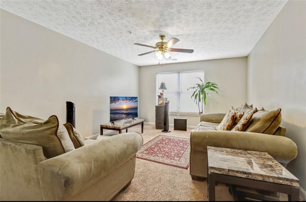 12303 Waldrop Place Decatur, GA 30034 - Photo 4 of 11 a living room with furniture and a ceiling fan