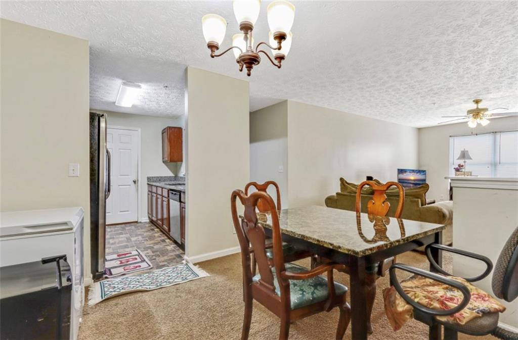 12303 Waldrop Place Decatur, GA 30034 - Photo 5 of 11 a view of a dining room with furniture and a chandelier
