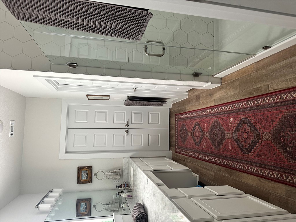 8600 Cumbrae Lane Austin, TX 78744 - Photo 12 of 29 Full bathroom featuring a shower stall, vanity, and dark wood-style floors
