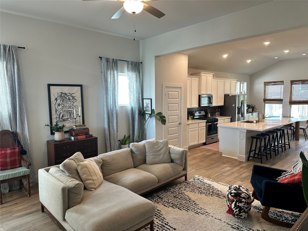 8600 Cumbrae Lane Austin, TX 78744 - Photo 2 of 29 Living room featuring light wood-style flooring, recessed lighting, lofted ceiling, and ceiling fan