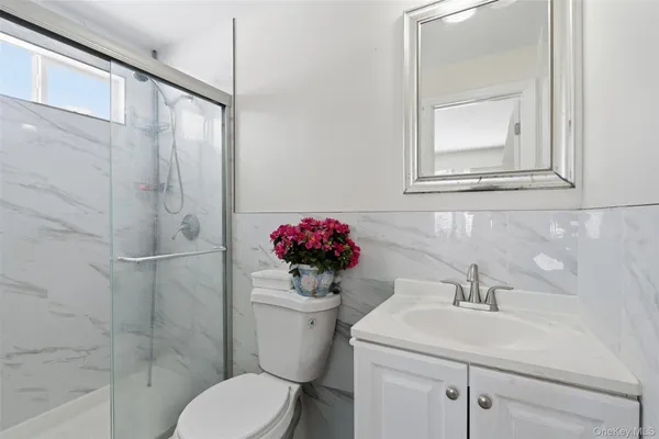 a white toilet sitting next to a bathroom sink