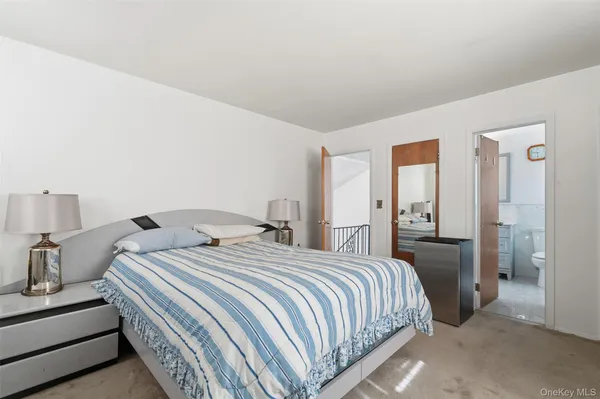 a bedroom with a bed and a lamp