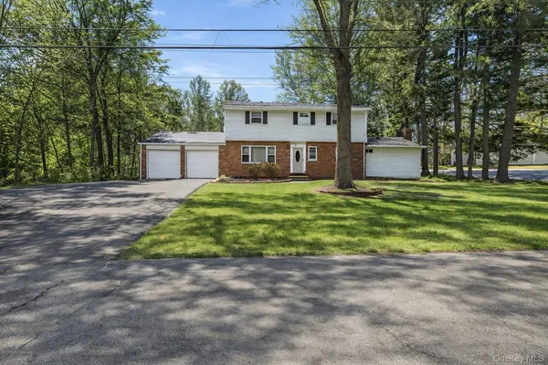 a view of a house with a yard and sitting area