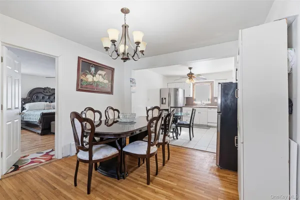 a view of a dining room with furniture and chandelier