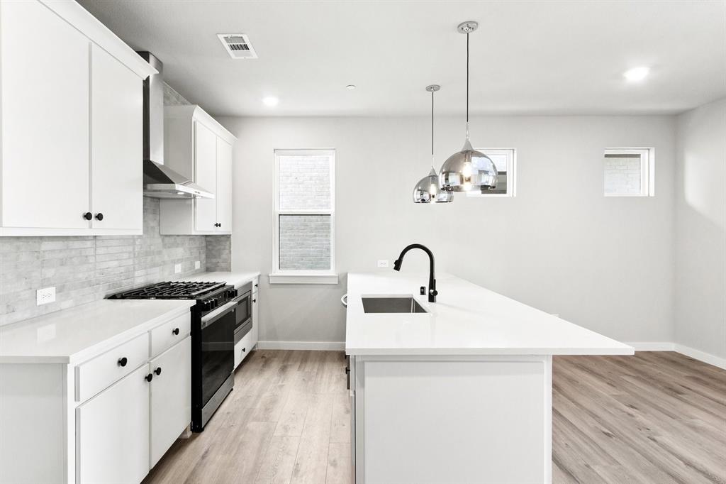 2020 Aldrich Road Celina, TX 75009 - Photo 16 of 40 a kitchen with stainless steel appliances granite countertop a sink stove and refrigerator