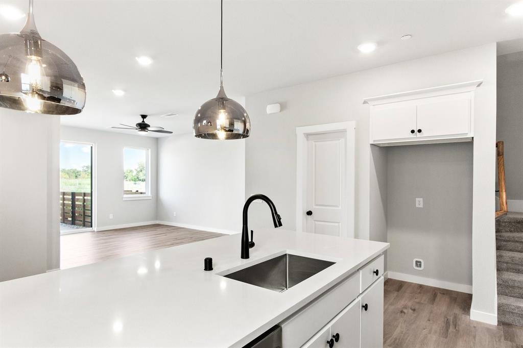 2020 Aldrich Road Celina, TX 75009 - Photo 17 of 40 a kitchen with granite countertop a sink and a refrigerator