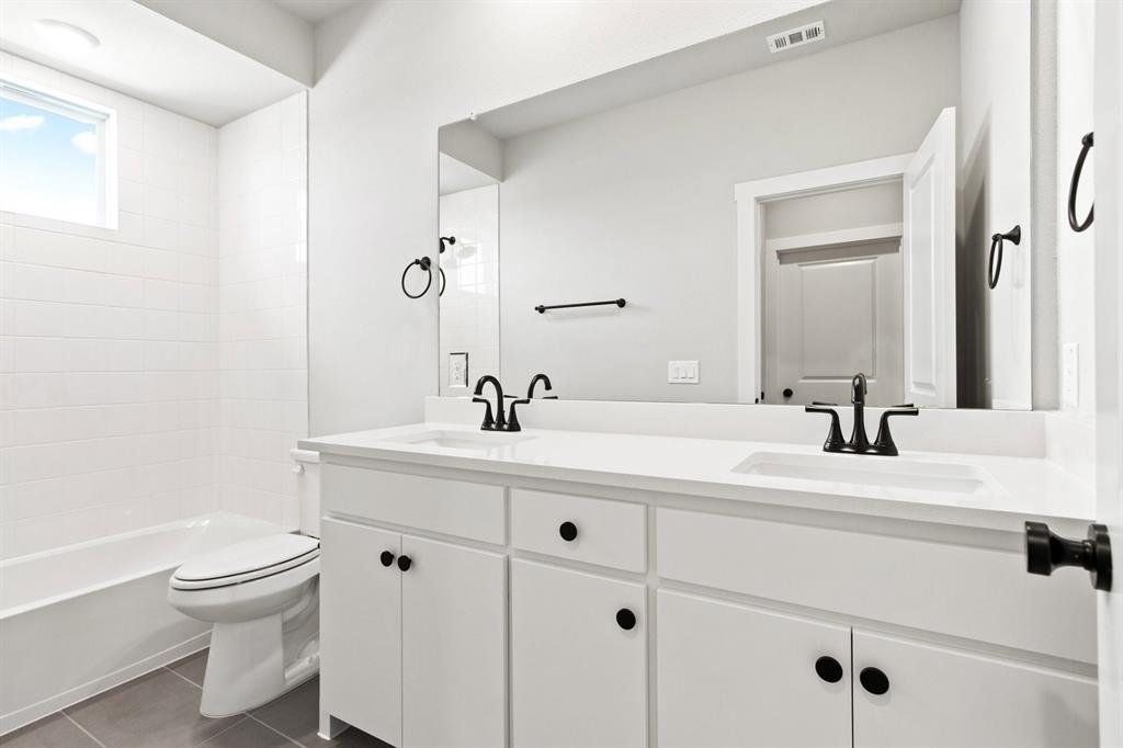 2020 Aldrich Road Celina, TX 75009 - Photo 32 of 40 a bathroom with a sink a toilet and a mirror