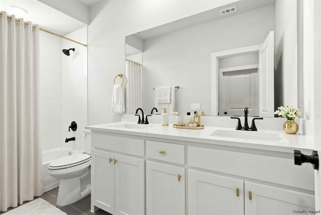 2020 Aldrich Road Celina, TX 75009 - Photo 33 of 40 a bathroom with a sink a toilet and a mirror