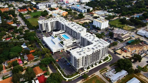 an aerial view of multiple houses with yard