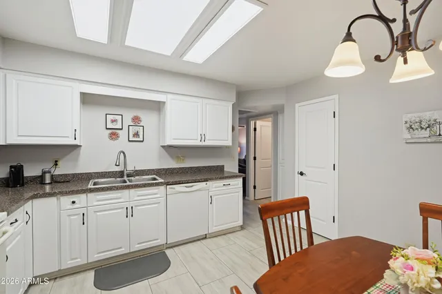 a kitchen with kitchen island granite countertop a table and chairs in it