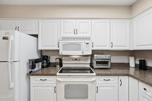 a kitchen with a sink cabinets and window