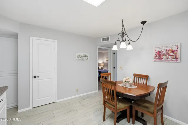 a kitchen with granite countertop white cabinets and sink