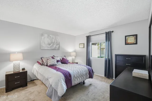 a kitchen with granite countertop white cabinets and refrigerator