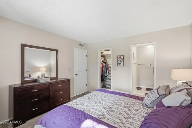 a bedroom with a bed and a lamp