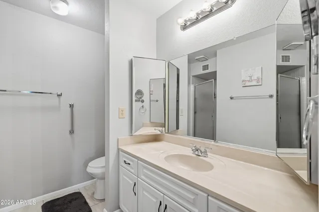 a bedroom with a bed and a lamp