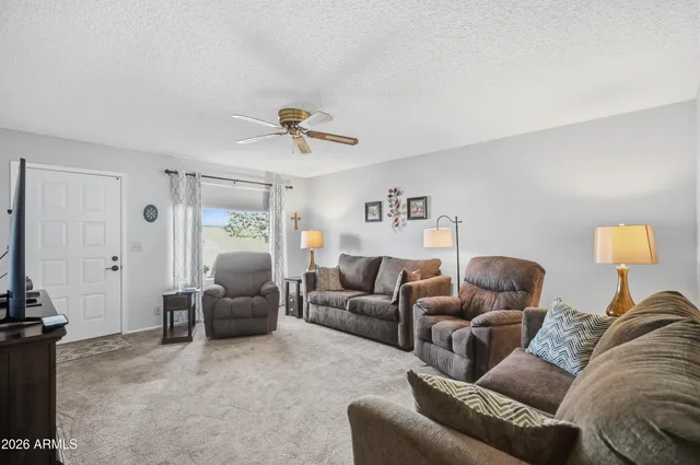 a living room with furniture a couch and a chandelier