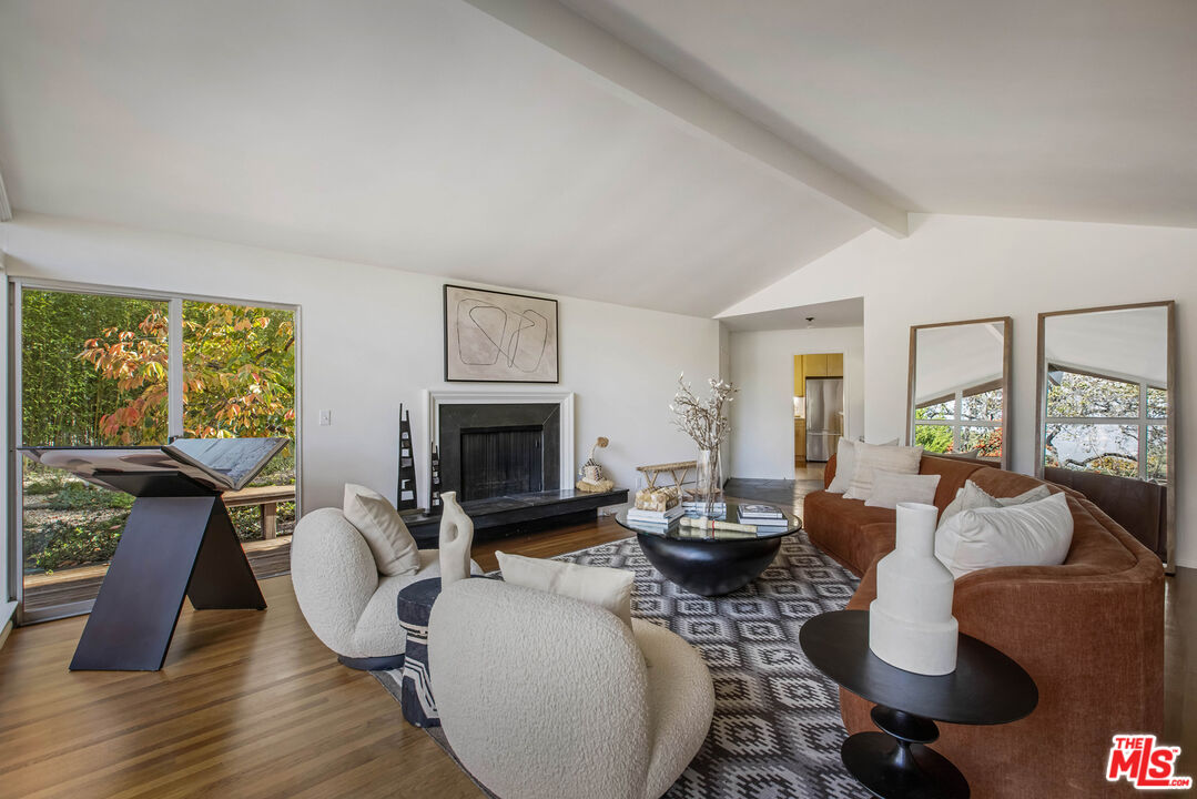 921 North San Marcos Road Santa Barbara, CA 93111 - Photo 11 of 44 a living room with furniture a fireplace and a floor to ceiling window
