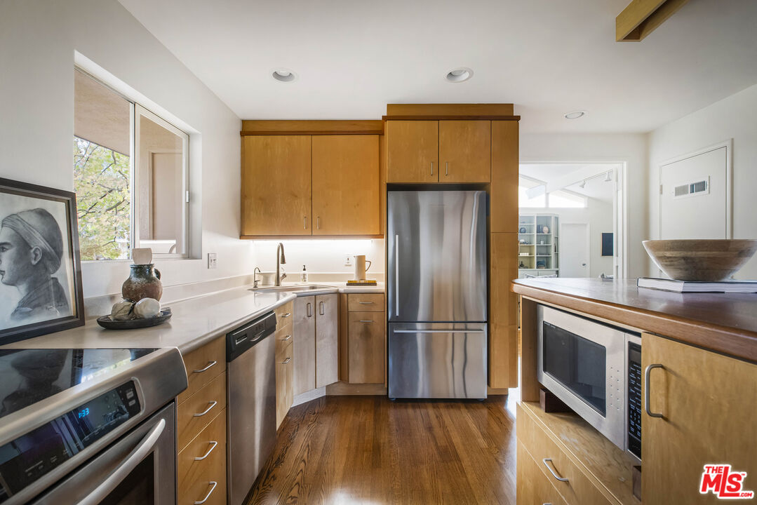921 North San Marcos Road Santa Barbara, CA 93111 - Photo 19 of 44 a kitchen with stainless steel appliances a sink cabinets and a wooden floor