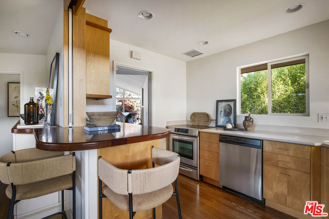 921 North San Marcos Road Santa Barbara, CA 93111 - Photo 20 of 44 a kitchen with granite countertop a sink chairs and wooden floor
