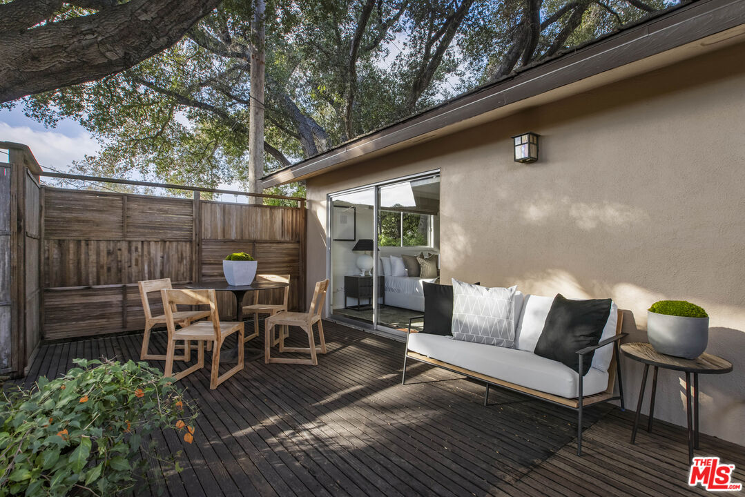 921 North San Marcos Road Santa Barbara, CA 93111 - Photo 23 of 44 a view of a patio with table and chairs potted plants with wooden floor and fence