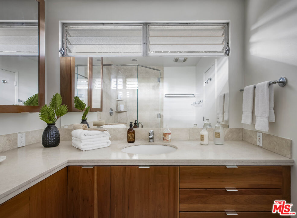 921 North San Marcos Road Santa Barbara, CA 93111 - Photo 26 of 44 a bathroom with a sink a vanity and a mirror