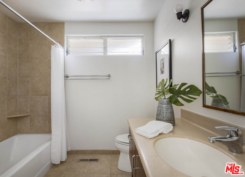 921 North San Marcos Road Santa Barbara, CA 93111 - Photo 30 of 44 a bathroom with a granite countertop sink a toilet and shower