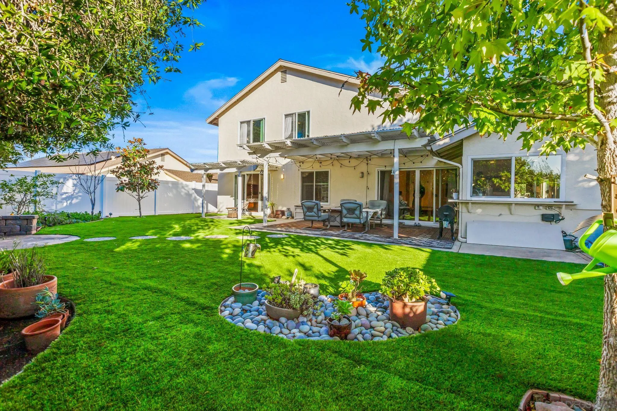 10831 Ironwood Road Scripps Ranch, CA 92131 - Photo 2 of 25 a front view of a house with a yard table and chairs